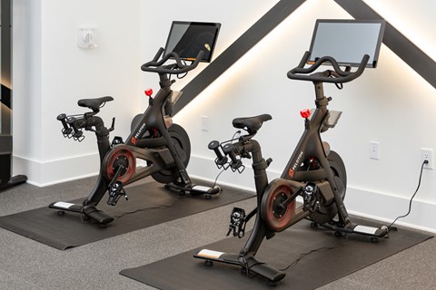 three exercise bikes in a room with a white wall