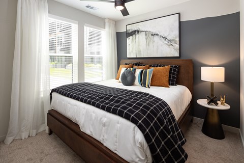 a bedroom with a large bed and a large window