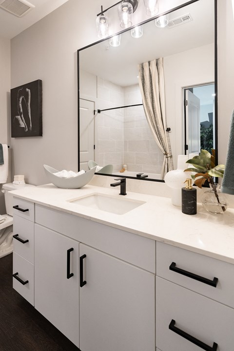 a white bathroom with a sink and a mirror