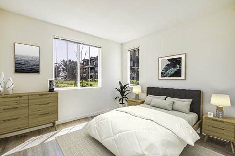 A bedroom with a large bed, a nightstand, and a window with a view of a tree and a building outside.
