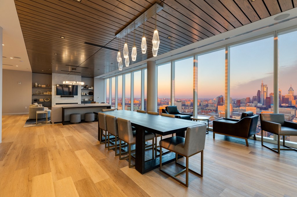 a dining room with a table and chairs and a view of the city