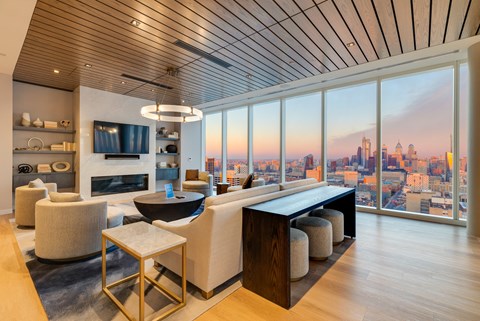 a living room with a view of a city and a table and chairs