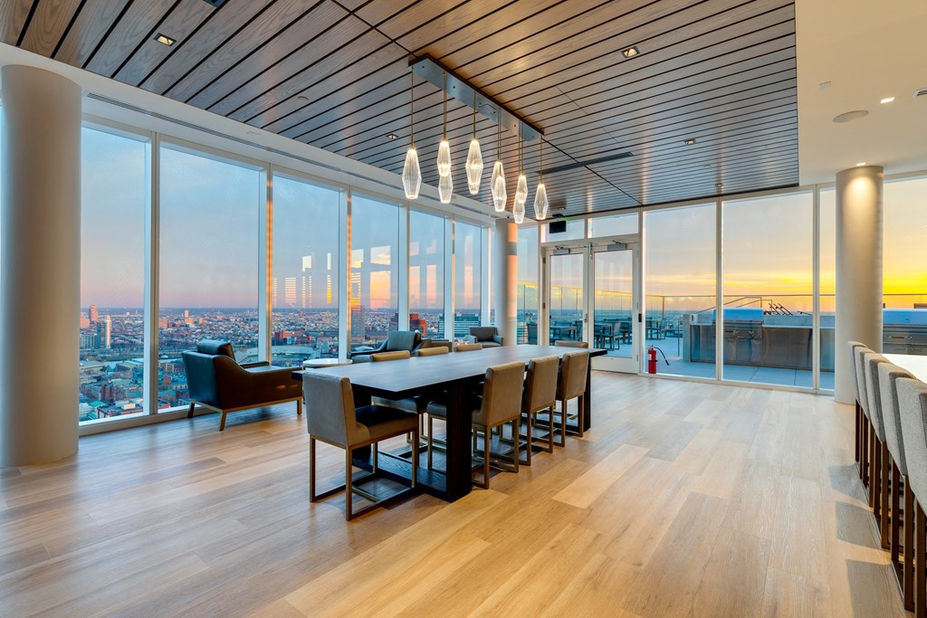 a dining room with a table and chairs and a view of the city