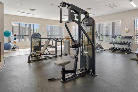 A gym with a variety of equipment including a leg press machine.