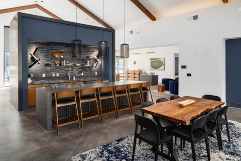 the kitchen and dining area of a modern house with a large table and chairs