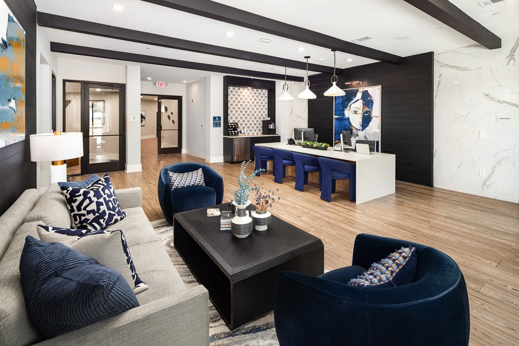 a living room and dining room with blue chairs and a table