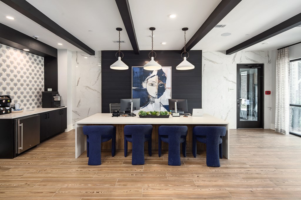 a dining room with a large table and blue chairs