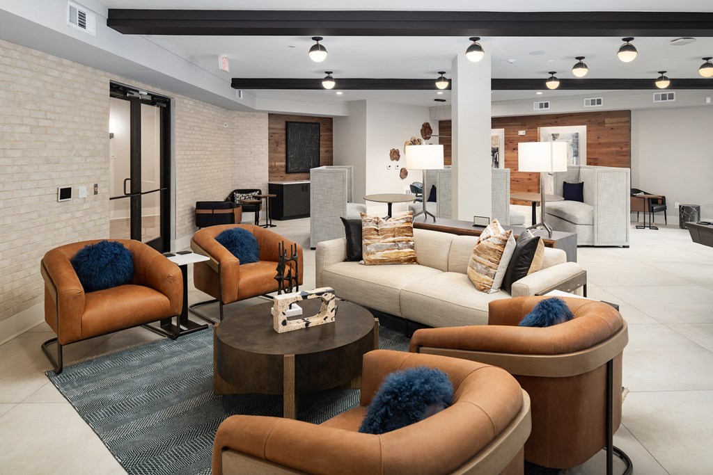 a living room with couches and chairs and a table