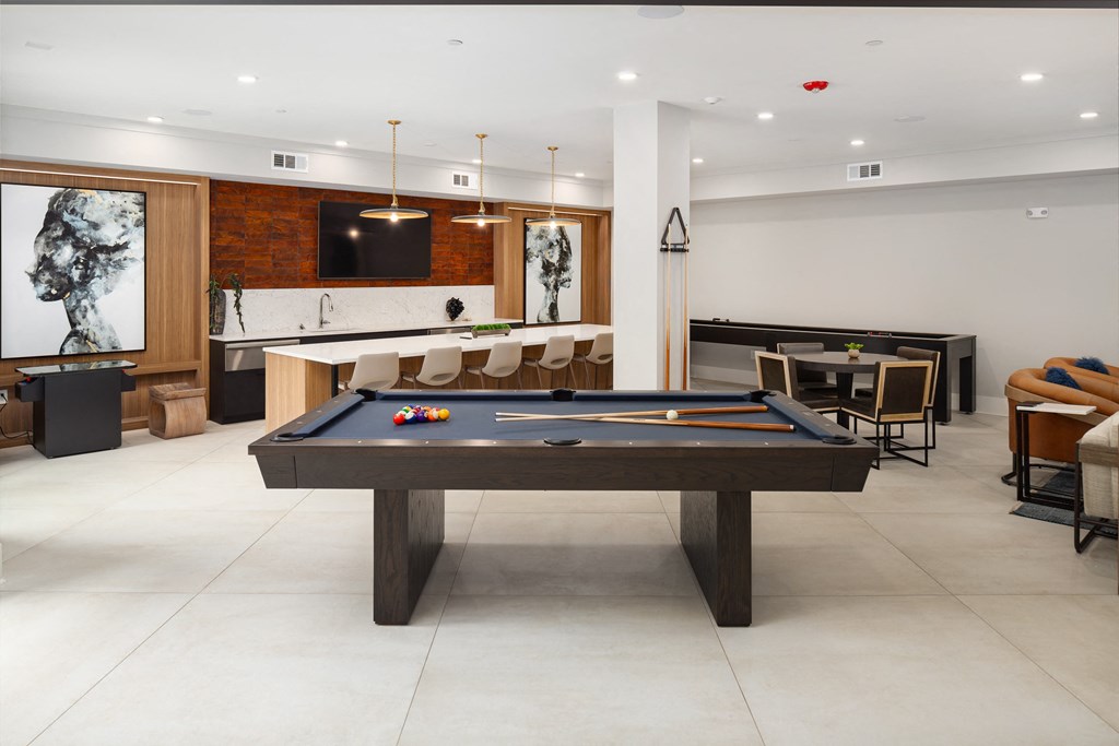 an open living room with a pool table and a bar