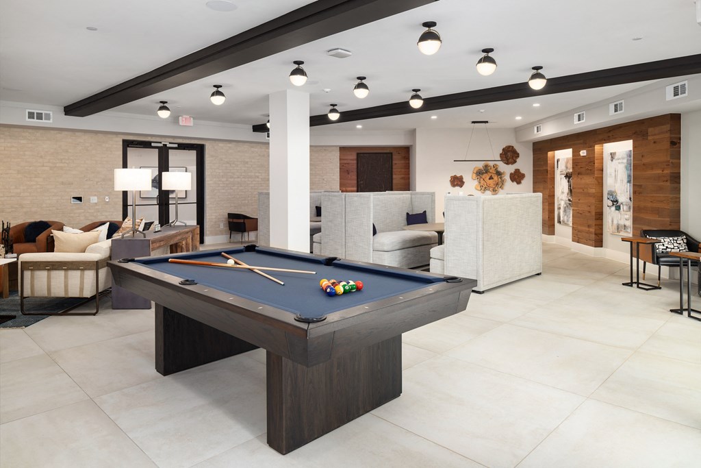 a clubhouse with a pool table in the middle of it