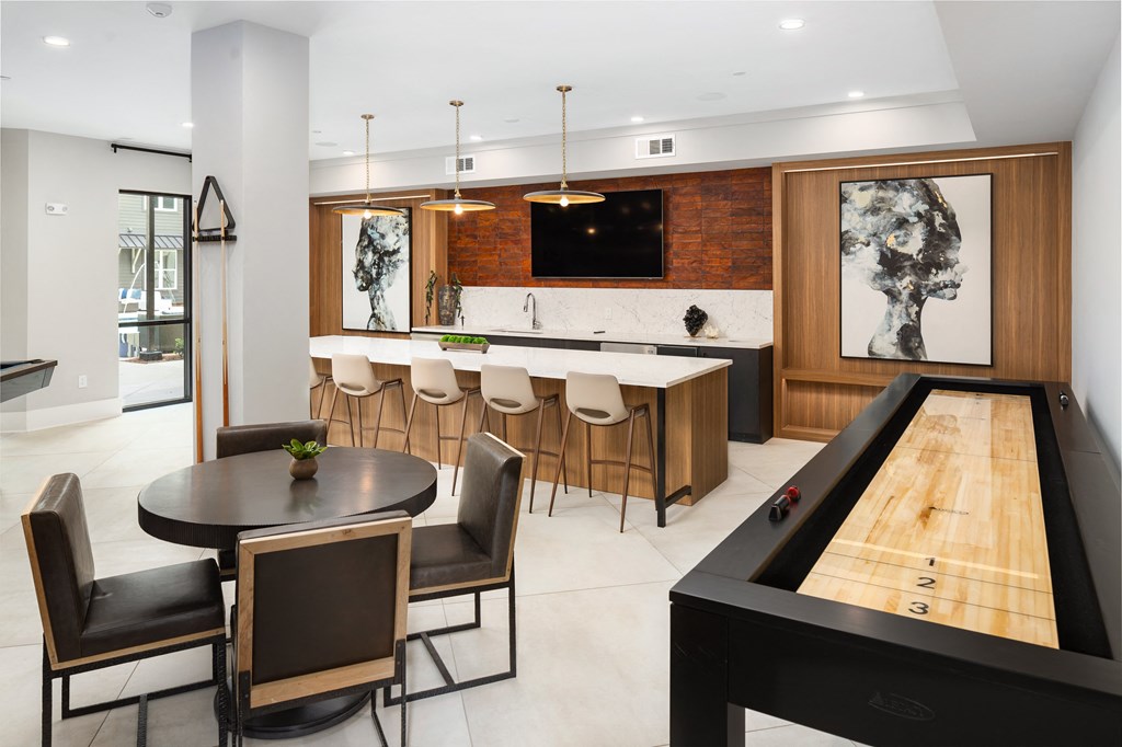 the kitchen and dining area of a modern house with a pool table