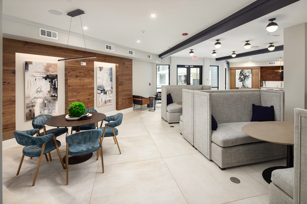 a living room with couches and a table and chairs