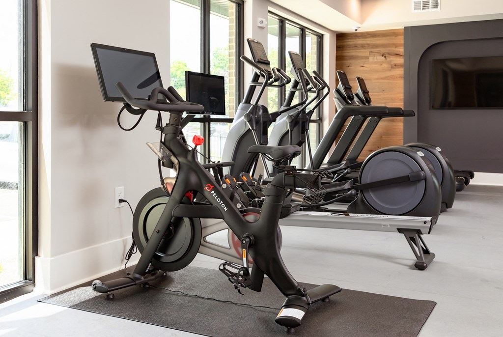 a row of exercise bikes in a gym