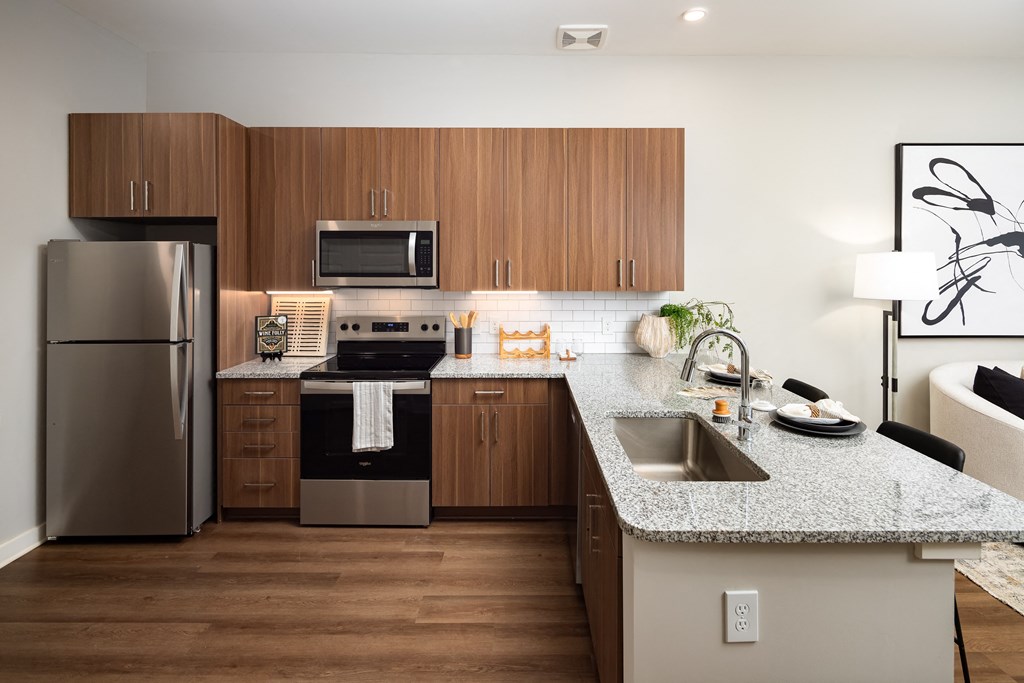 a kitchen with stainless steel appliances and granite counter tops