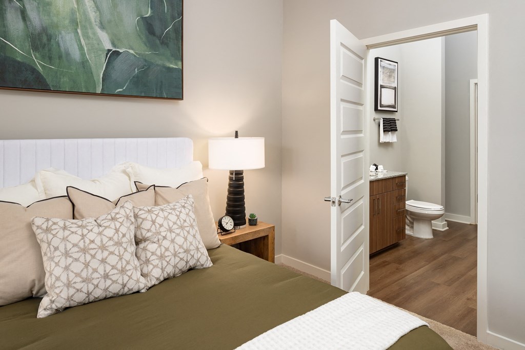 a bedroom with a bed and a bathroom with a toilet