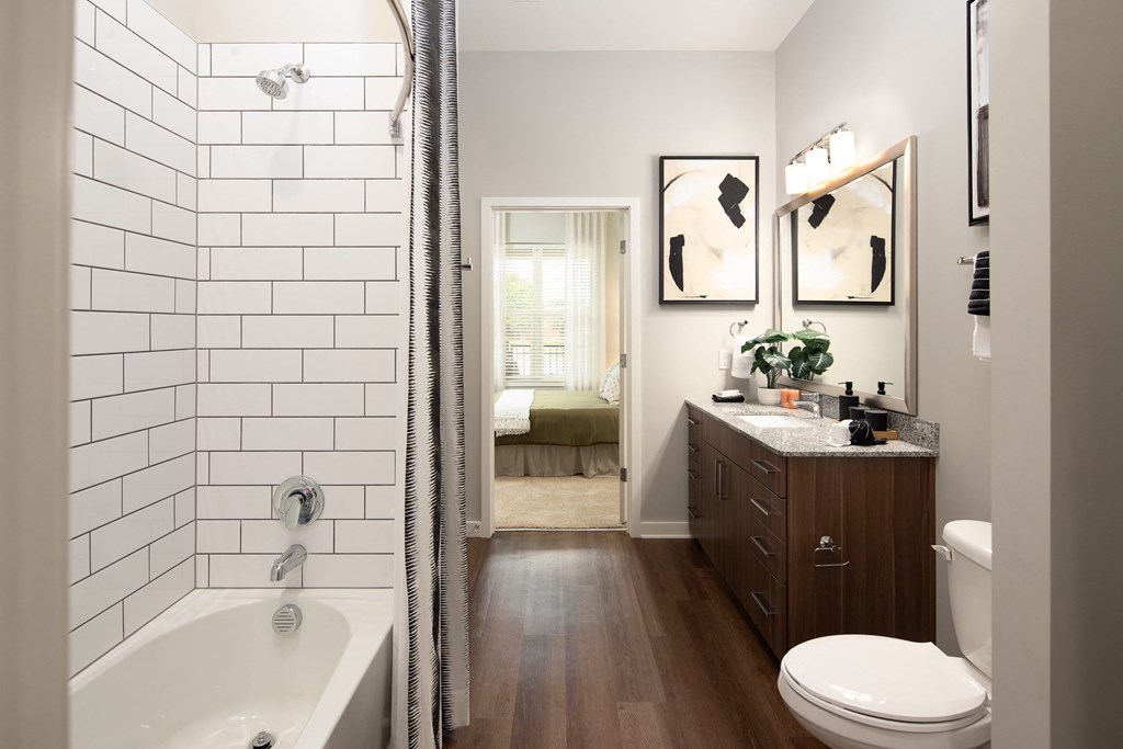 a bathroom with a shower and a sink and a toilet