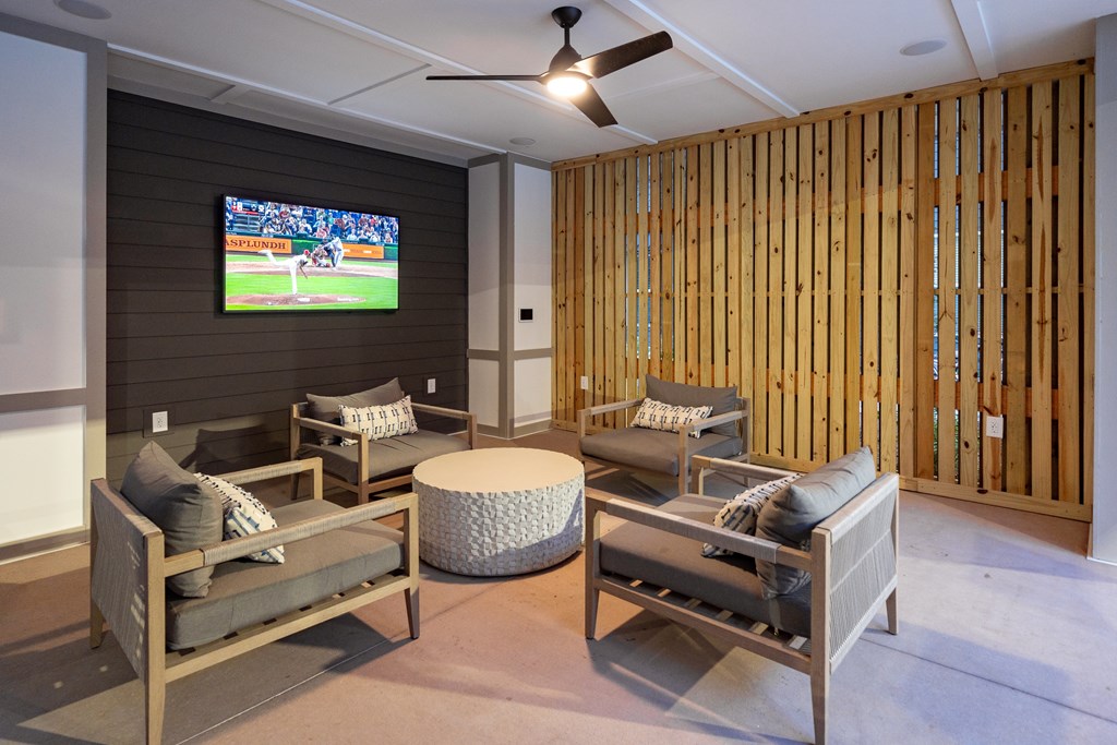 A room with a television and a wooden wall.