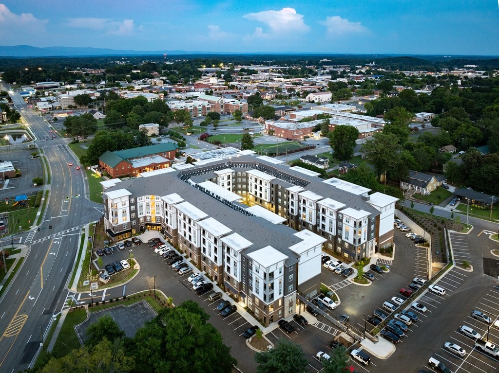 A large building with a parking lot in front of it.