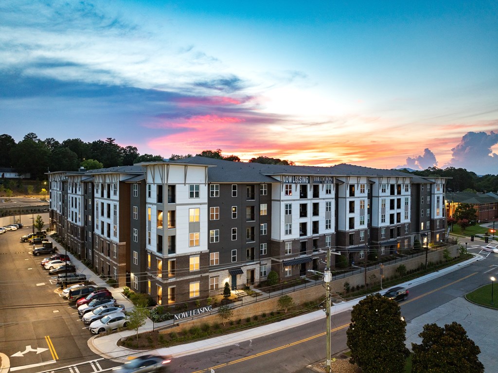 A large apartment complex is shown with a parking lot in front.