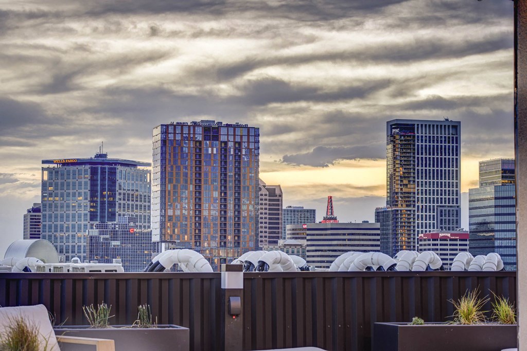 a view of the city skyline from a rooftop bar