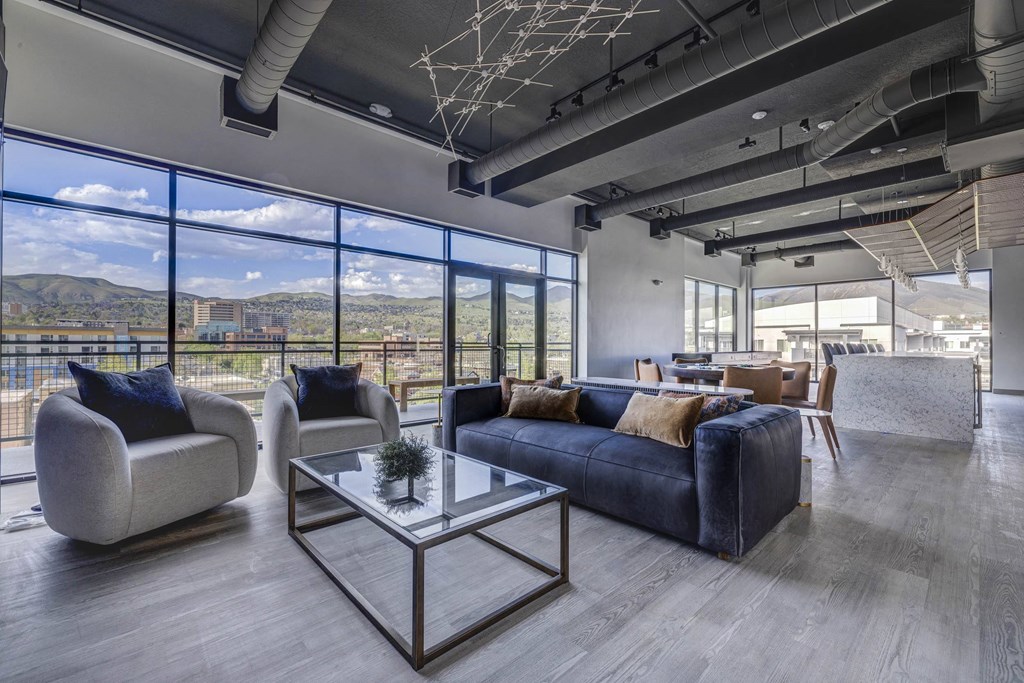 a clubroom with couches and chairs and a table