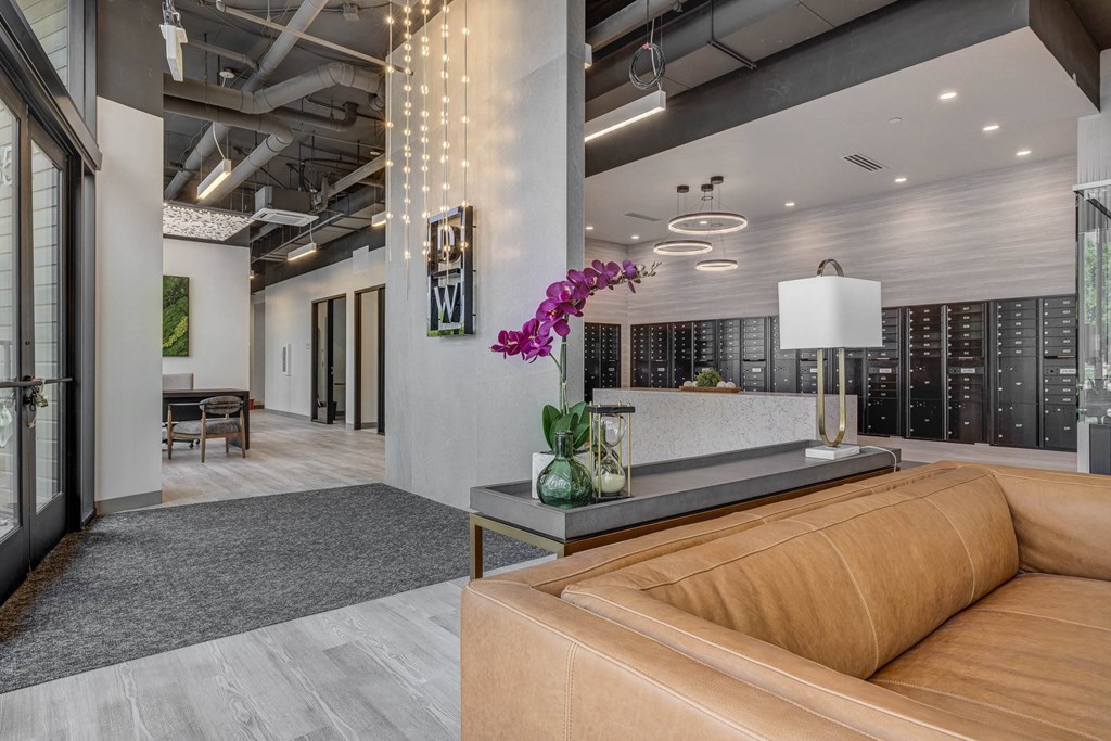 a lobby with a brown couch and a table