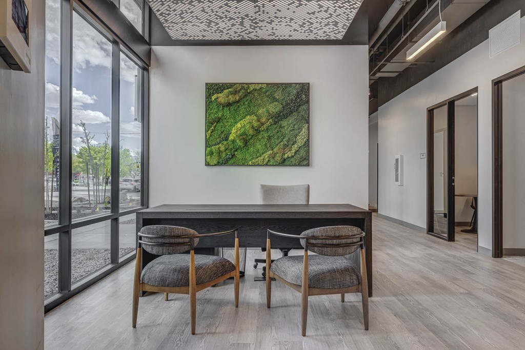 a working table with a table and three chairs