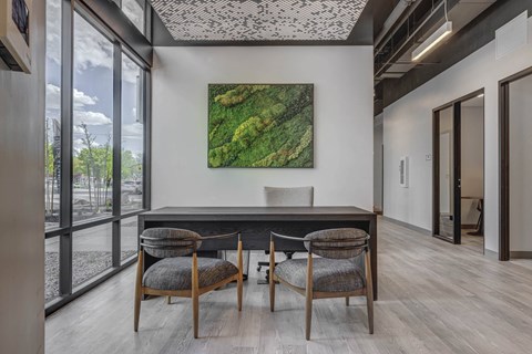 a working table with a table and three chairs