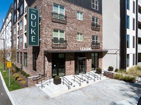 The Duke building is a brick apartment complex with a leasing office.