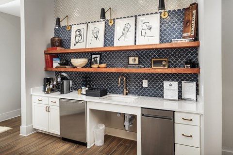A kitchen with a white counter top and a black and white tile backsplash.