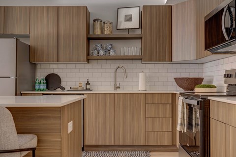 A kitchen with wooden cabinets and a white countertop.