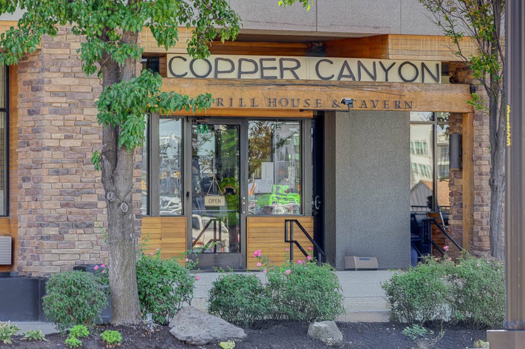 The front of the Copper Canyon Rill House & Tavern with a tree in front.