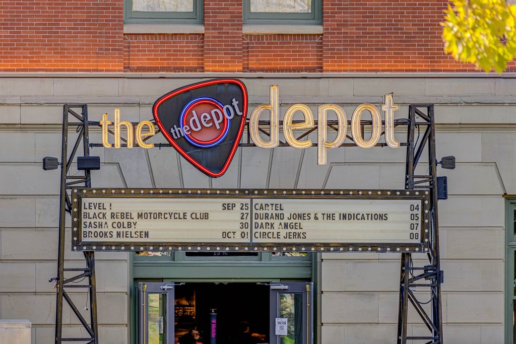A signboard for The Depot shows a series of dates and names.