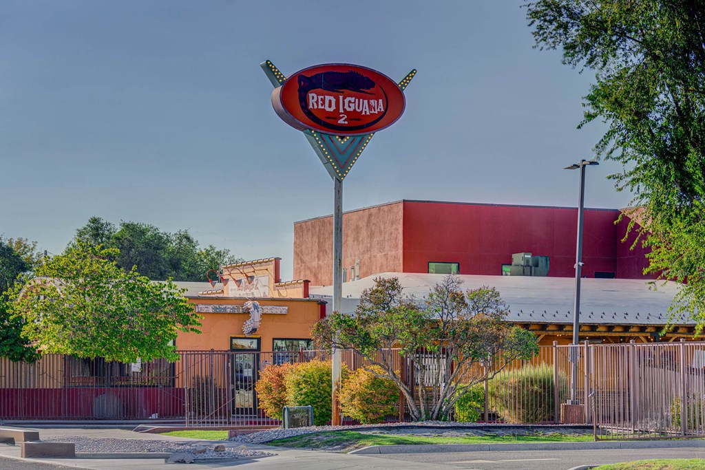 A Red Iguana sign is in front of a building.