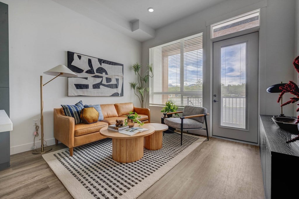 A living room with a brown sofa and a coffee table.