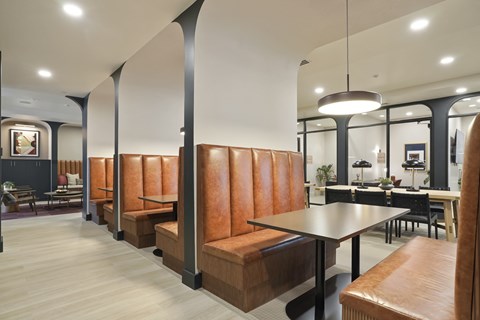 A modern dining area with a long table and chairs.