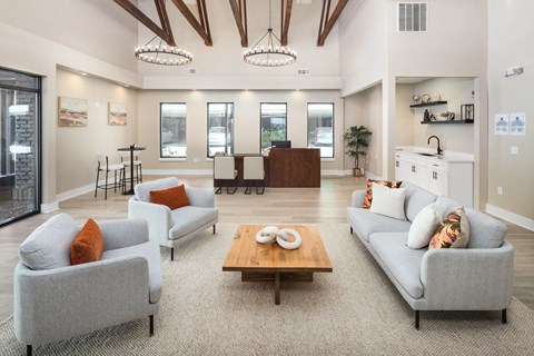 A living room with a grey couch, a wooden coffee table, and a fireplace.