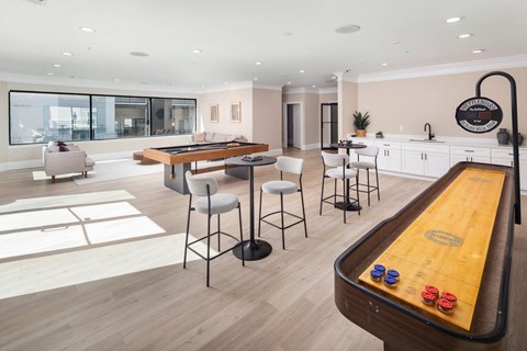 A billiard table is in the middle of a well-furnished room.