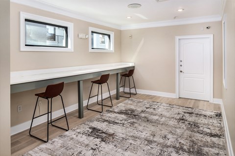 A room with a long table and chairs.