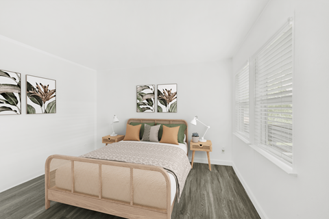 A bedroom with a bed, nightstands, and pictures on the wall.