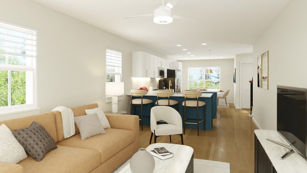 A living room with a couch, chairs, and a television.