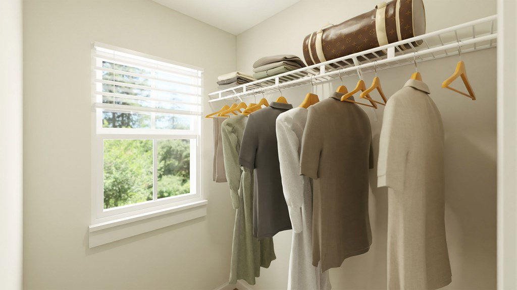 Clothes hanging on a rack in a room.