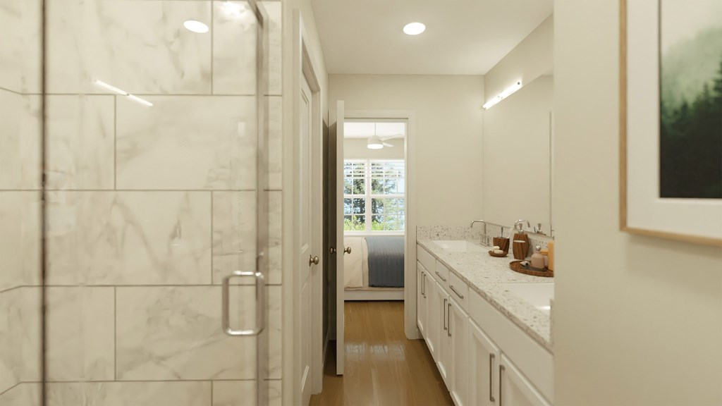 A bathroom with a marble tile shower and a white vanity.