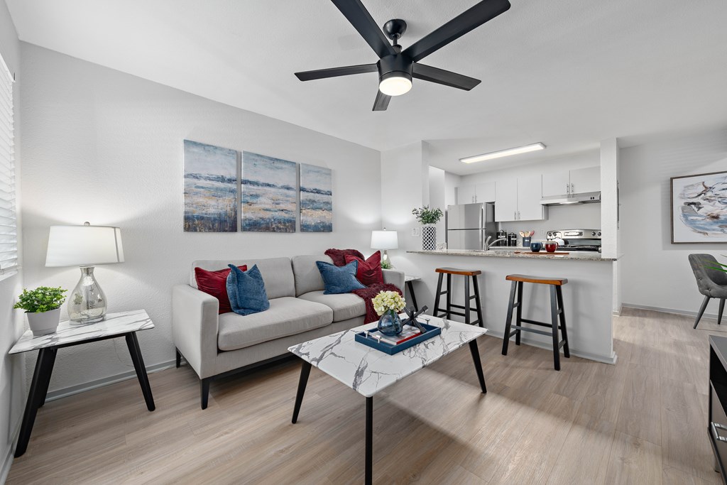 Living room with grey sofa at The Halifax apartments in Phoenix, AZ.