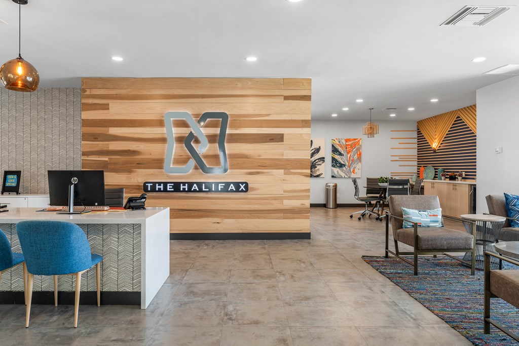 A reception area with a wooden wall and a sign that says "The Halifax".