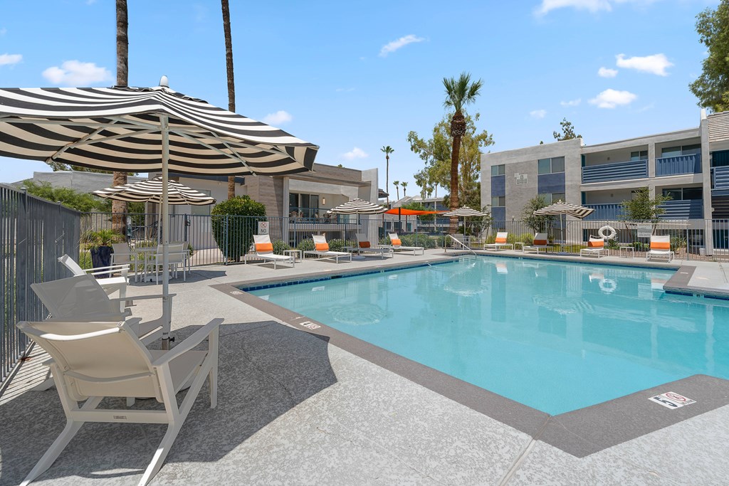 Umbrella table with chairs and grilling station at The Halifax apartments in Phoenix, AZ.