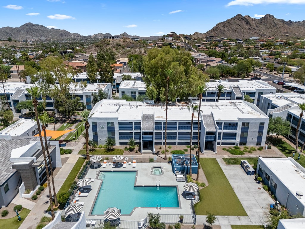 A large building with a pool in front of it.