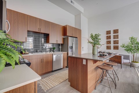 A modern kitchen with wooden cabinets and a white countertop.