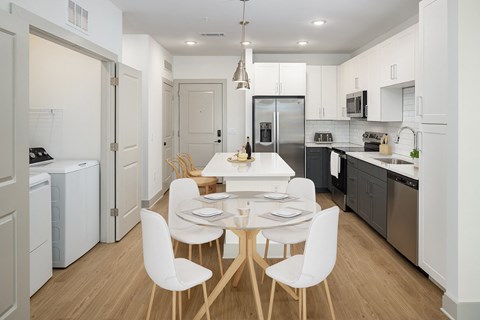 a kitchen and dining room with a table and chairs