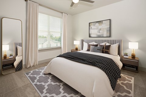 a bedroom with a large bed and a window